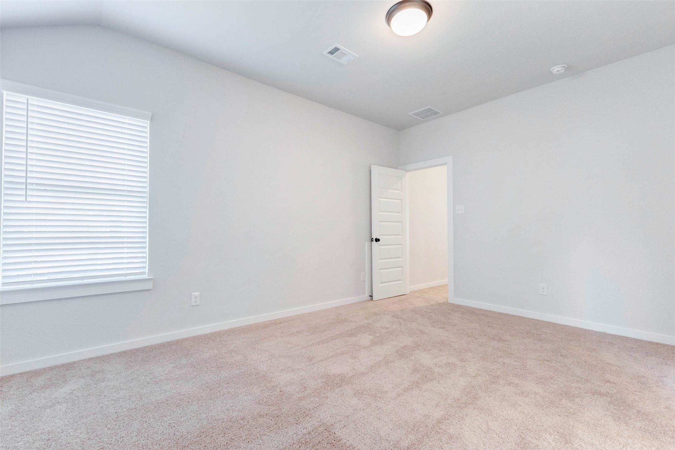 6406 Pomona Court Rosharon, TX 77583 - Photo 27 of 33 This upstairs secondary bedroom offers a peaceful retreat with plush carpet, soft neutral tones, and a large window bringing in natural light. Whether used as a guest suite, office, or kid’s room, the space is versatile and move-in ready.