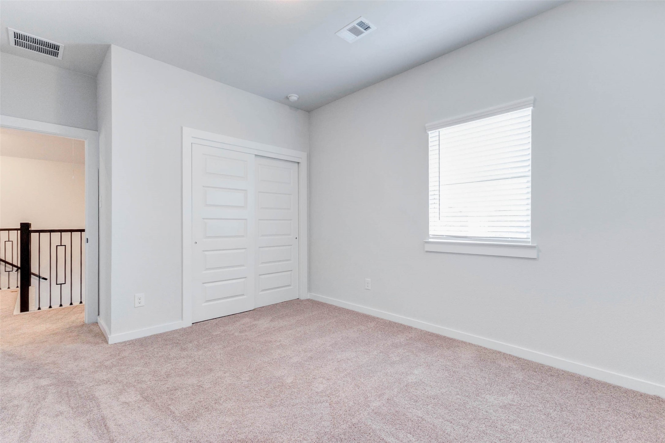 6406 Pomona Court Rosharon, TX 77583 - Photo 29 of 33 A cozy secondary bedroom upstairs features soft carpeting, a large window, and a double-door closet for added storage. Its location just off the game room makes it ideal for a flexible guest room, study, or creative space.