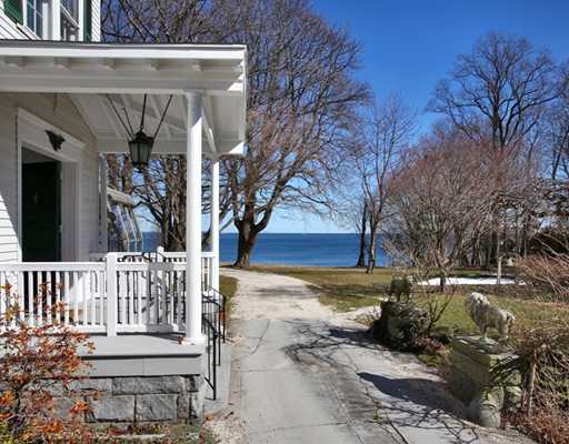 Undisclosed Address Darien, CT 06820 - Photo 4 of 9 a view of a house with large trees and wooden fence