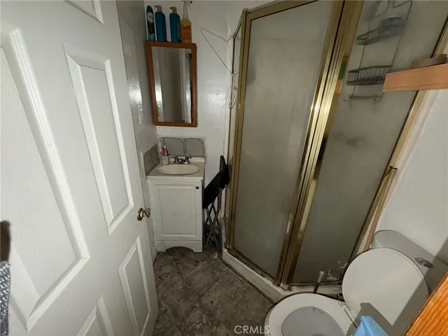 a bedroom with a bed and a mirror