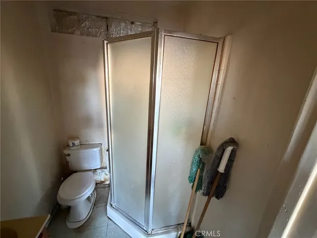 a bedroom with a bed and a mirror