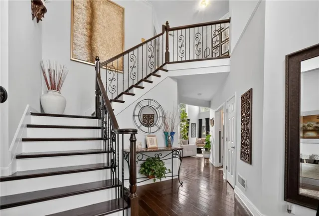 a view of entryway and hall with wooden floor