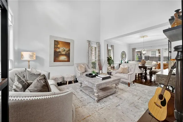 a living room with furniture flowerpot and a lamp