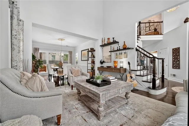 a living room with furniture and a potted plant