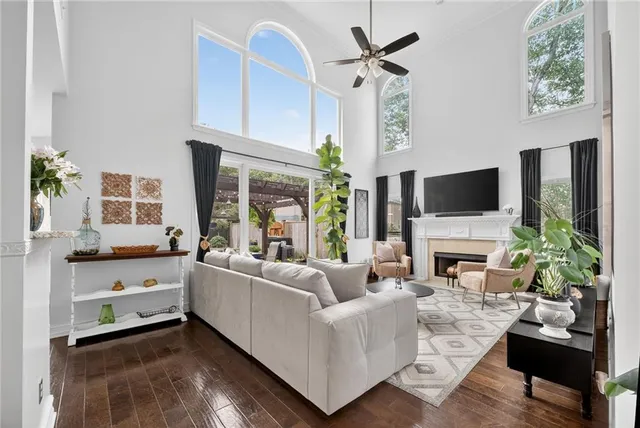 a living room with furniture a fireplace and a flat screen tv