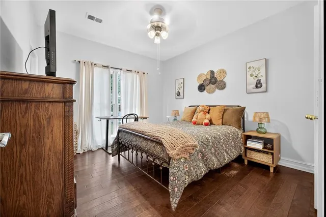 a bedroom with a bed lamp and a window