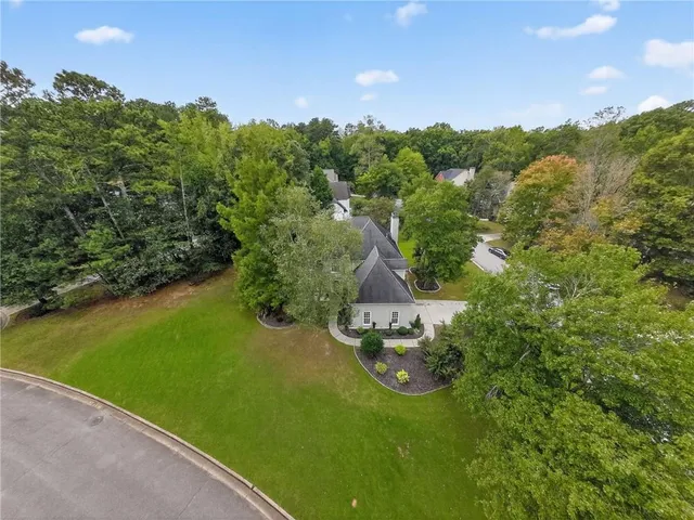 an aerial view of a house with a yard