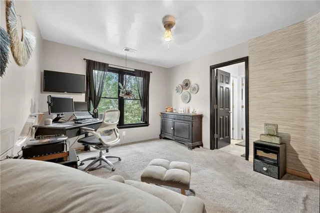 a bedroom with furniture a bed and a flat screen tv