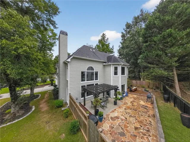 a view of a house with backyard sitting area and garden