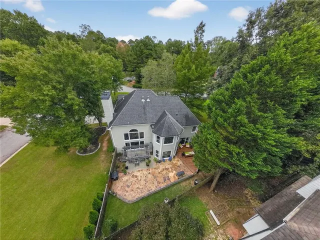 an aerial view of a house with garden space and a patio