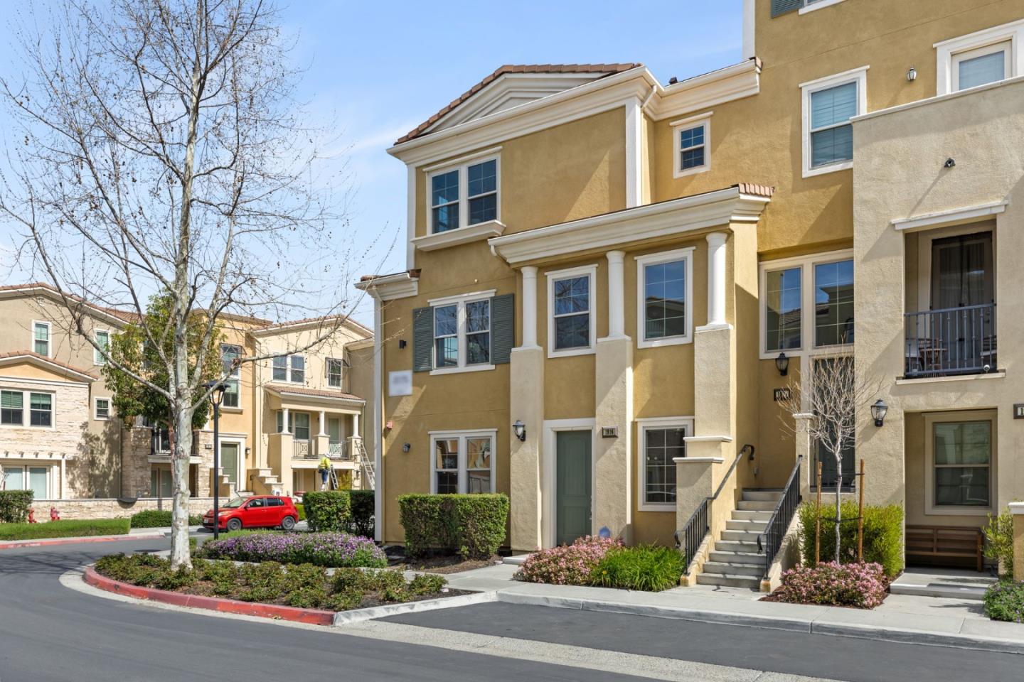 a front view of multi story residential apartment building with yard