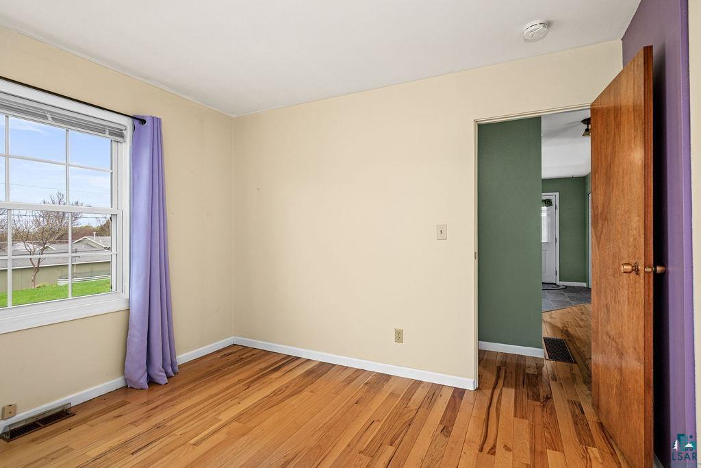 33 Nelson Drive Silver Bay, MN 55614 - Photo 18 of 40 Empty room featuring baseboards, light wood-type flooring, and a smoke detector