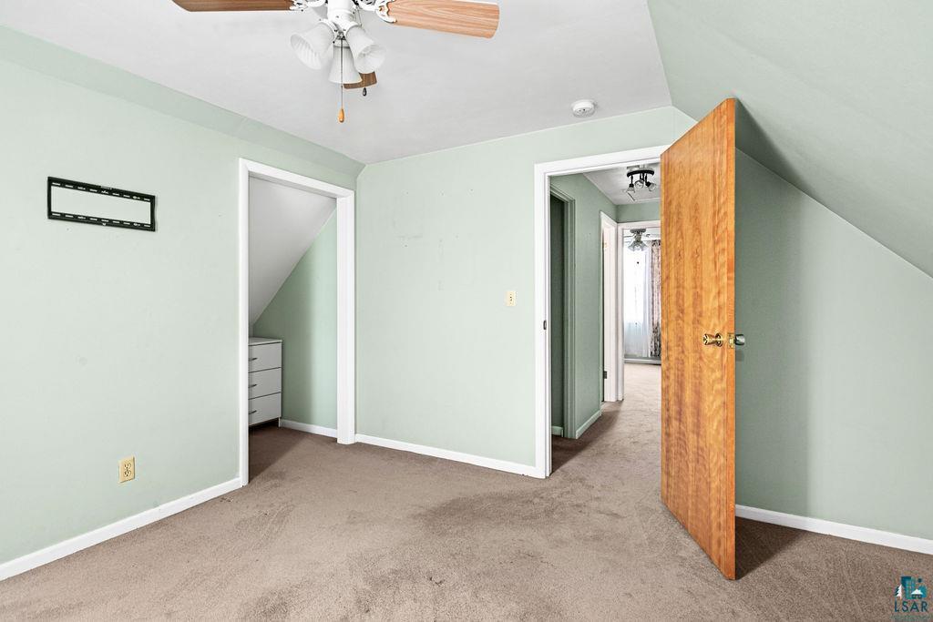 33 Nelson Drive Silver Bay, MN 55614 - Photo 21 of 40 Unfurnished bedroom with carpet, lofted ceiling, baseboards, and a ceiling fan
