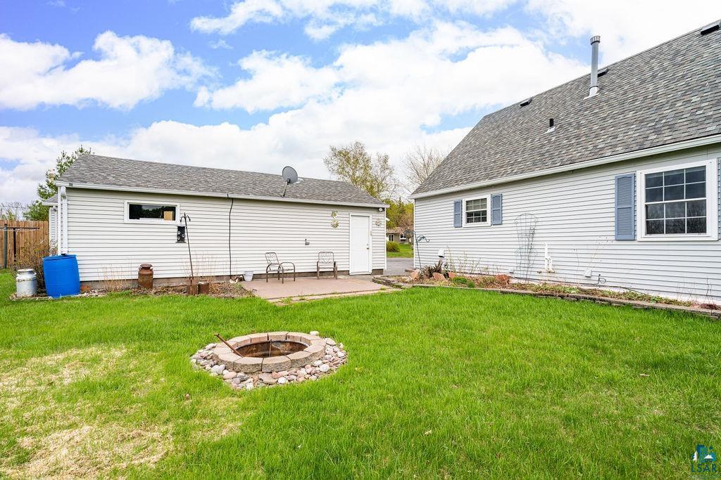 33 Nelson Drive Silver Bay, MN 55614 - Photo 7 of 40 Rear view of property featuring an outdoor fire pit, a patio area, and a lawn