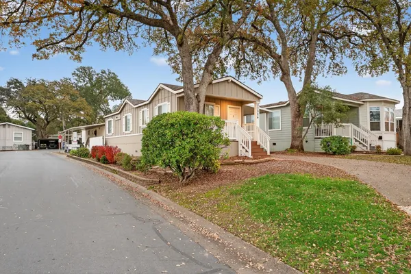 a front view of a house with a yard and a bike