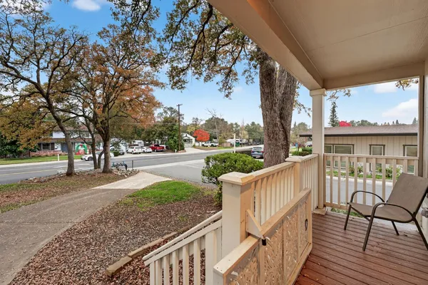 a view of a street with wooden fence