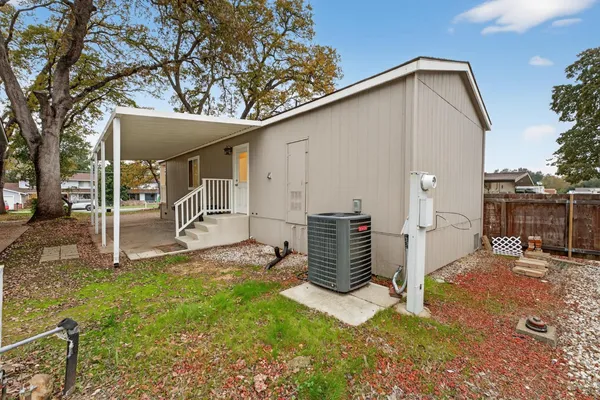 a backyard of a house with table and chairs