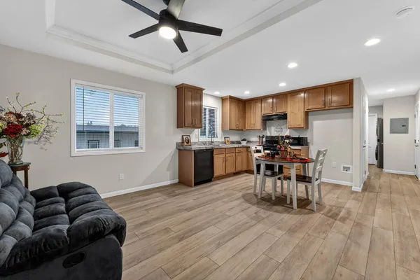 a living room with stainless steel appliances kitchen island granite countertop furniture and a kitchen view