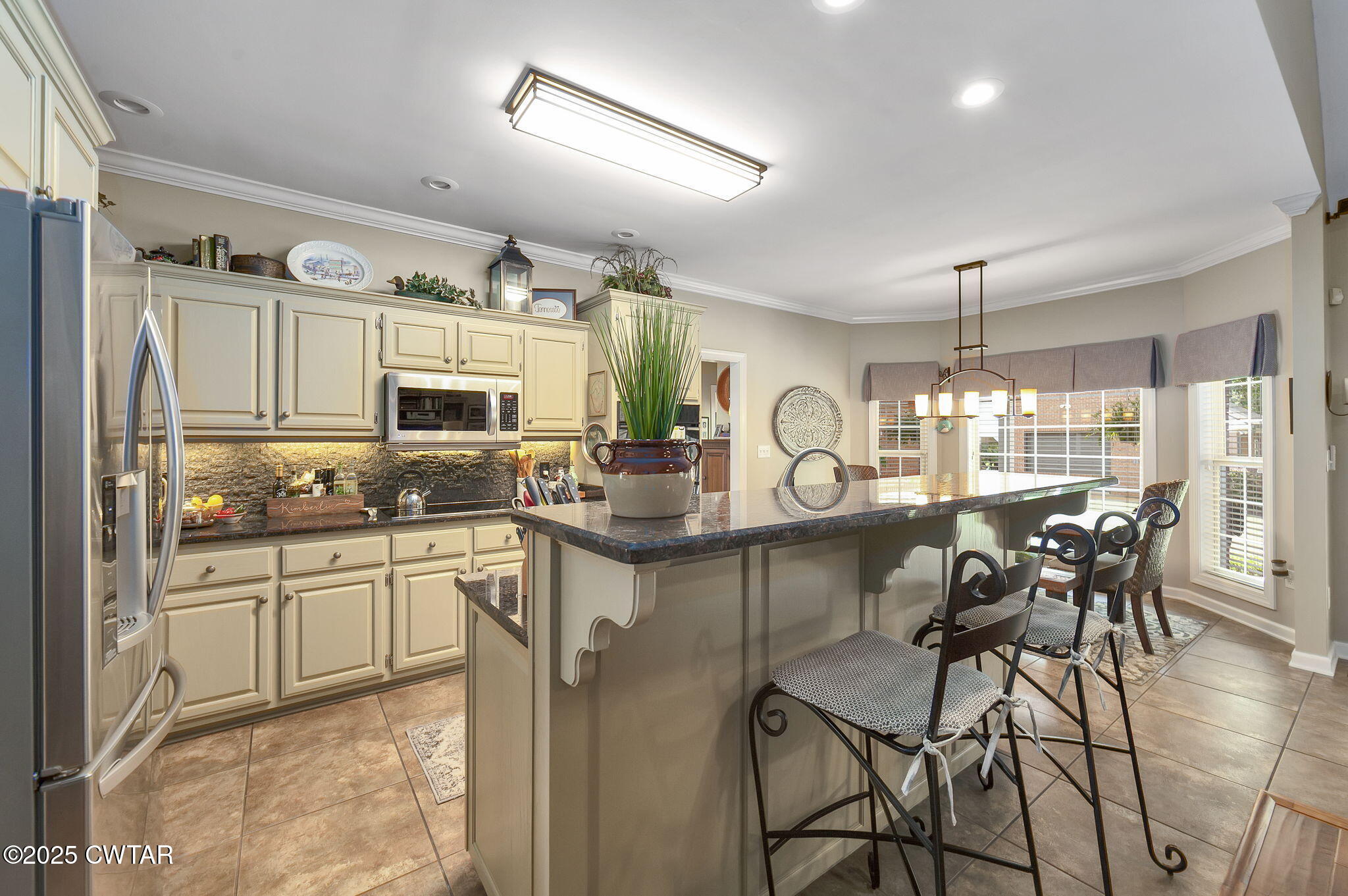 180 Medon Malesus Road Medon, TN 38356 - Photo 15 of 73 a kitchen with stainless steel appliances granite countertop a table and chairs in it