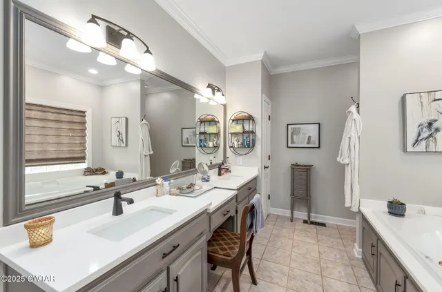 an aerial view of residential house with outdoor space and trees all around