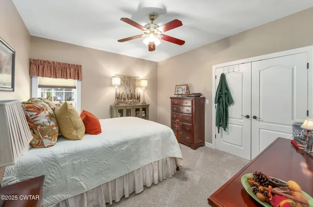 an aerial view of residential house with outdoor space and trees all around