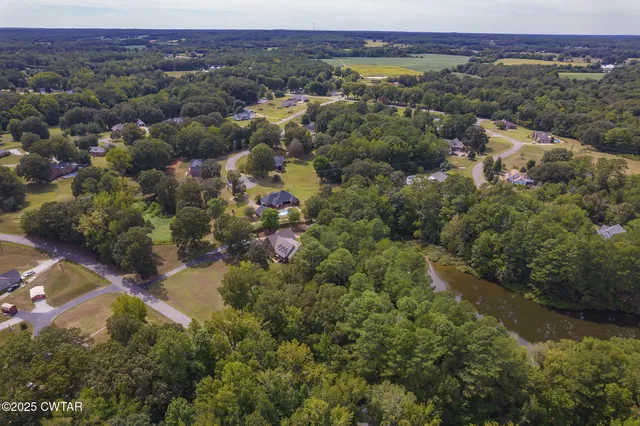 an aerial view of house with yard swimming pool and outdoor seating