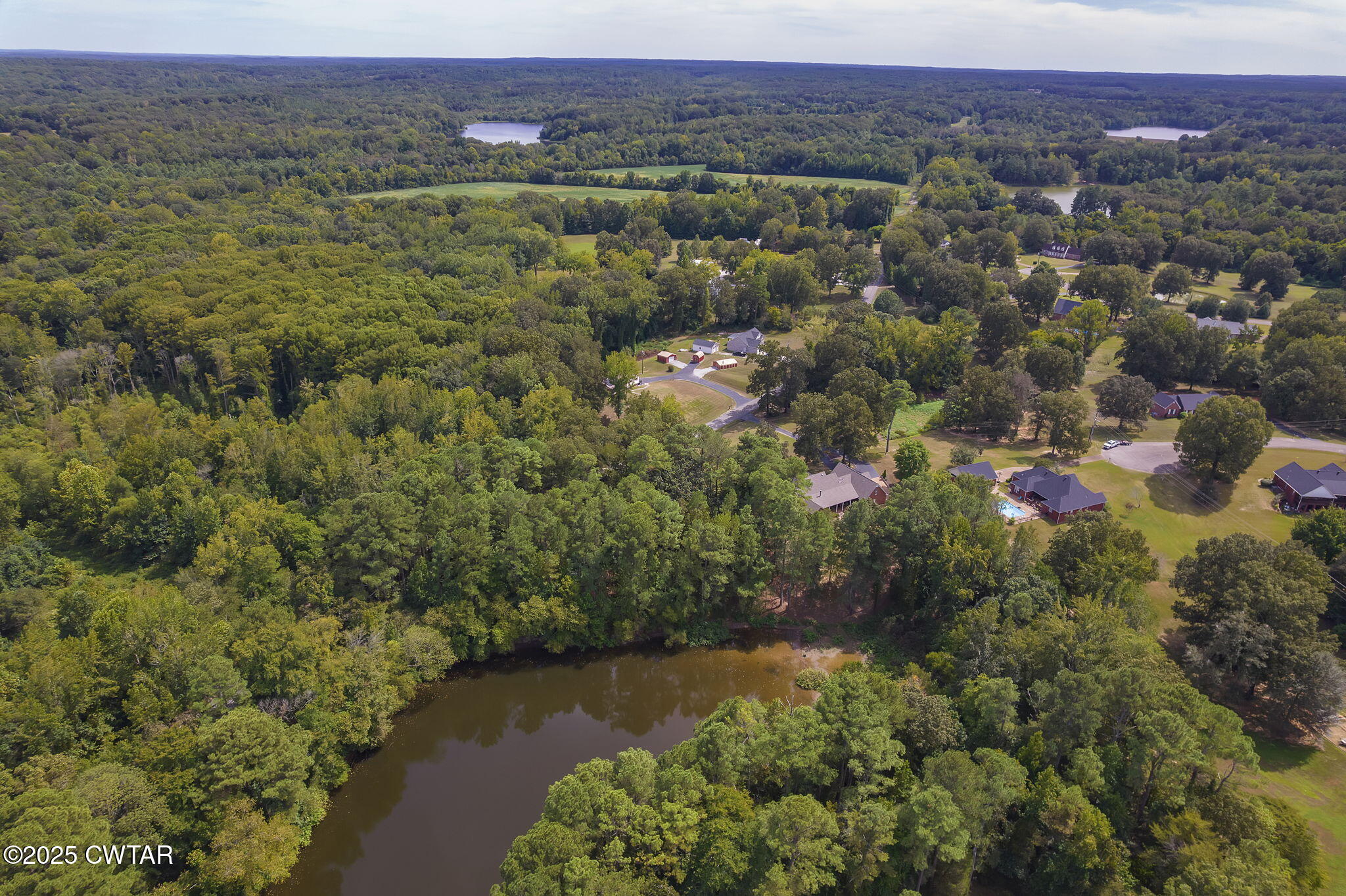 180 Medon Malesus Road Medon, TN 38356 - Photo 39 of 73 an aerial view of a houses with a lush green hillside