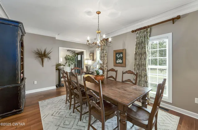 a living room with furniture a fireplace and a chandelier