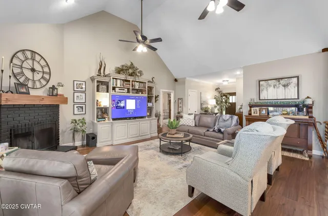 a living room with furniture and a view of kitchen