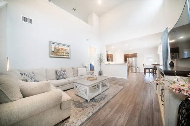 a living room with furniture and a wooden floor