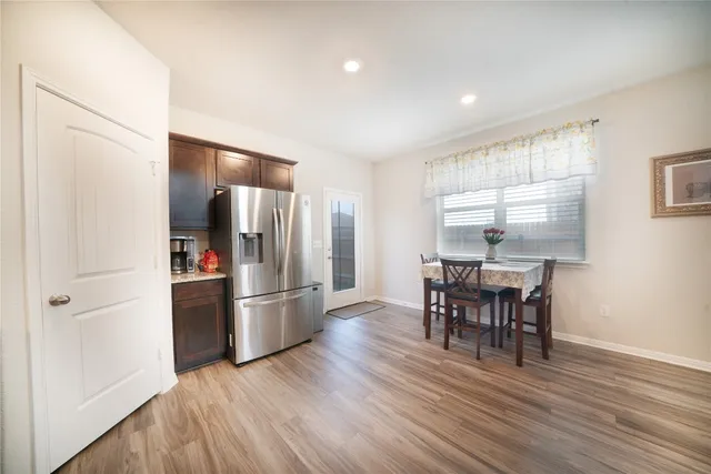 a kitchen with stainless steel appliances granite countertop a refrigerator and a stove top oven