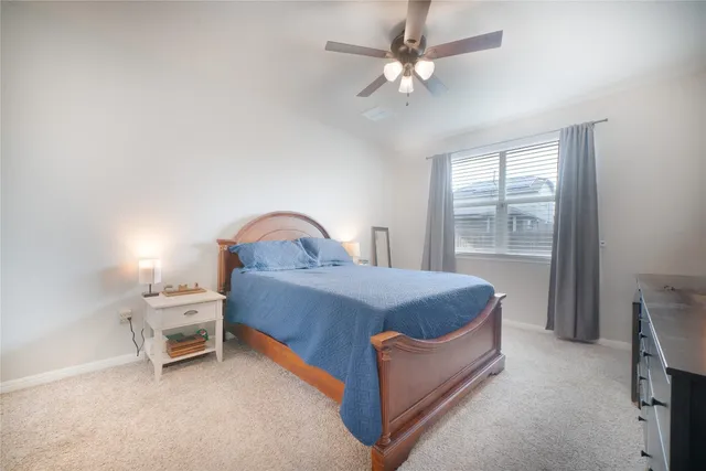 a spacious bedroom with a bed and a window