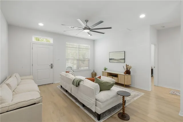a living room with furniture and a large window