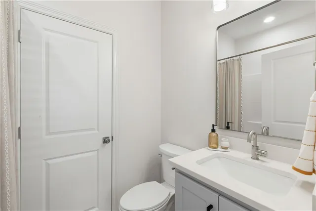 a bathroom with a sink toilet and vanity