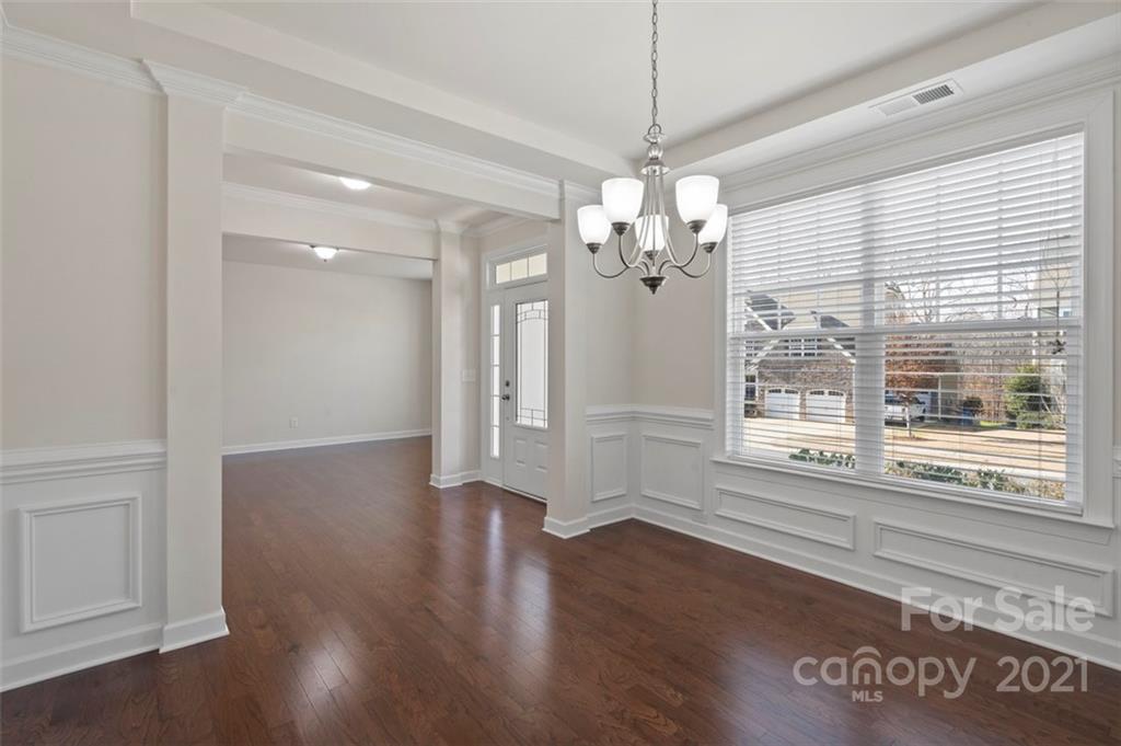 4331 Oxford Mill Road Waxhaw, NC 28173 - Photo 7 of 48 a view of a room with wooden floor chandelier and windows