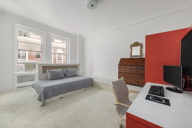 a bedroom with a bed and glass windows