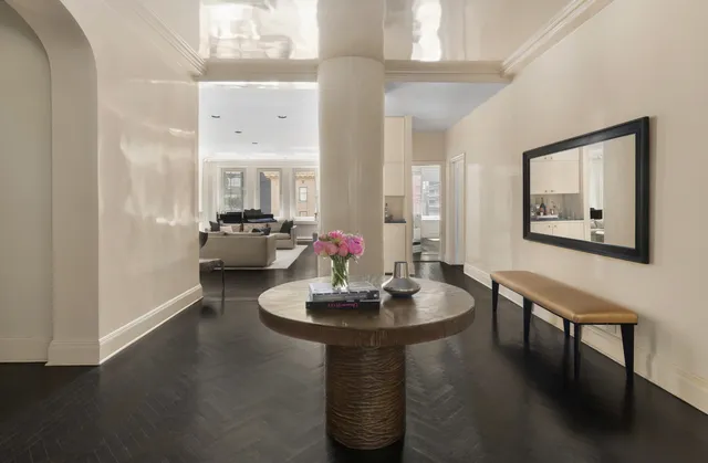 a living room with furniture fireplace and a large window