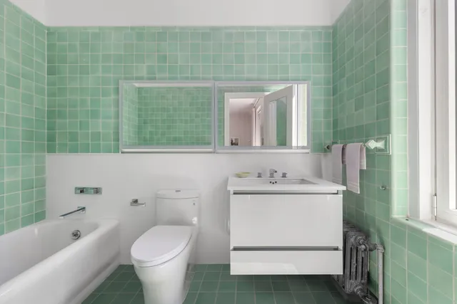 a spacious bedroom with a bed and wooden floor