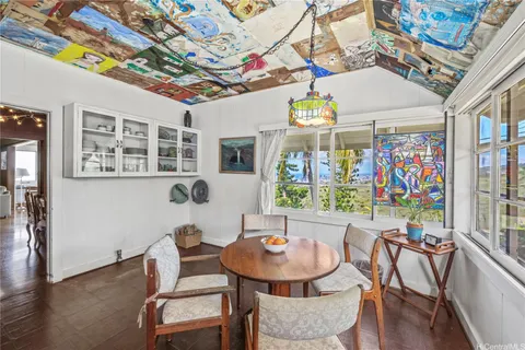 a view of a dining room with furniture a chandelier and wooden floor