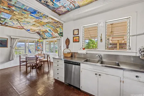 a kitchen with sink attached with living room