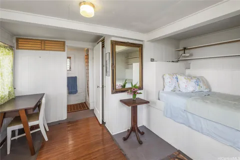 a view of a room that has a bed and a chair in it