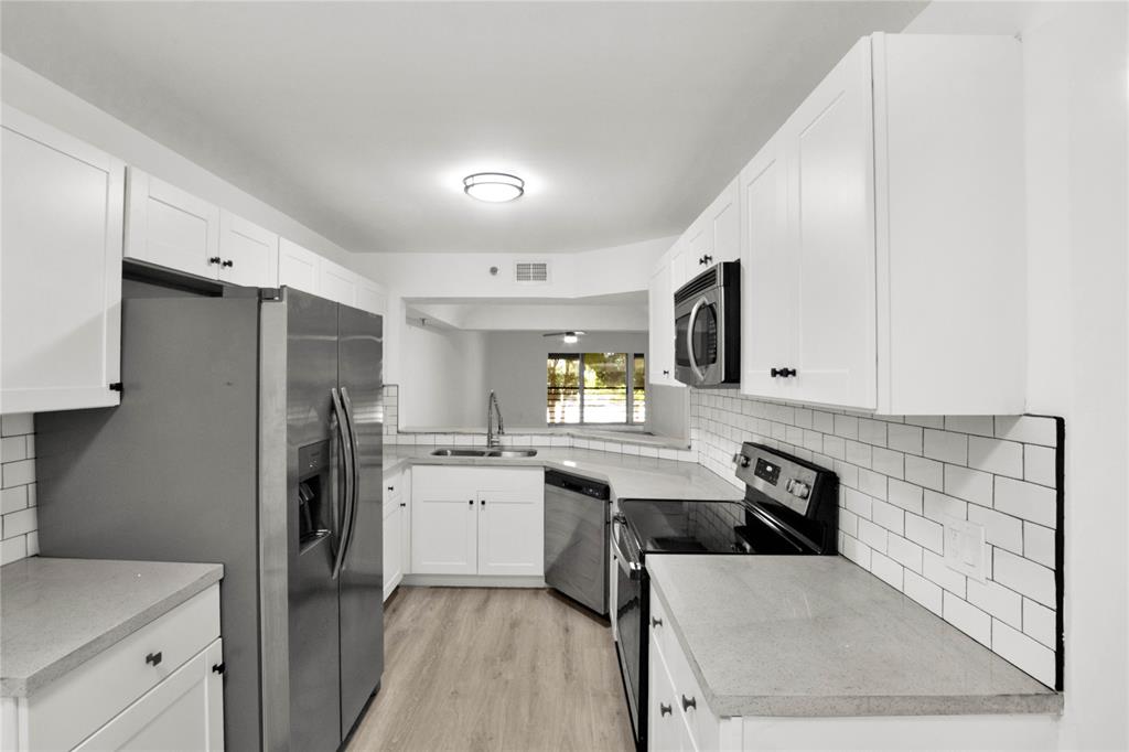 a kitchen with a refrigerator and a sink