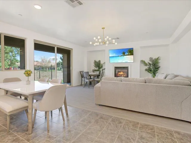 a kitchen with stainless steel appliances granite countertop a stove top oven a sink dishwasher and a refrigerator with white cabinets