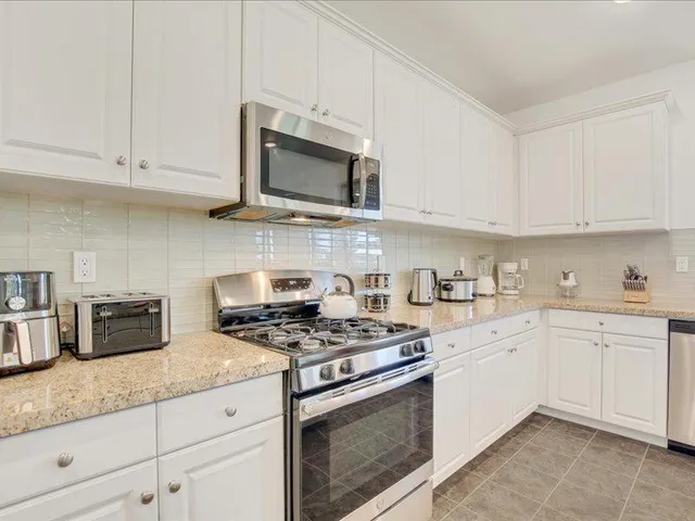 a view of kitchen island a sink and living room