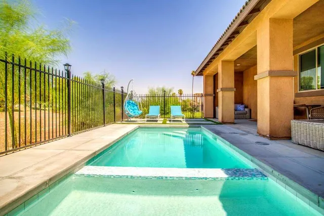 a balcony with table and chairs