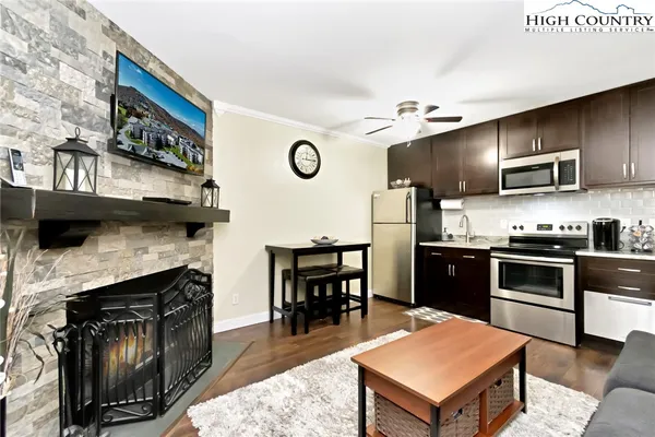 a kitchen with kitchen island a stove and a refrigerator