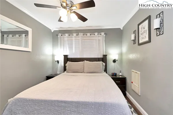 a bedroom with a large bed and a chandelier