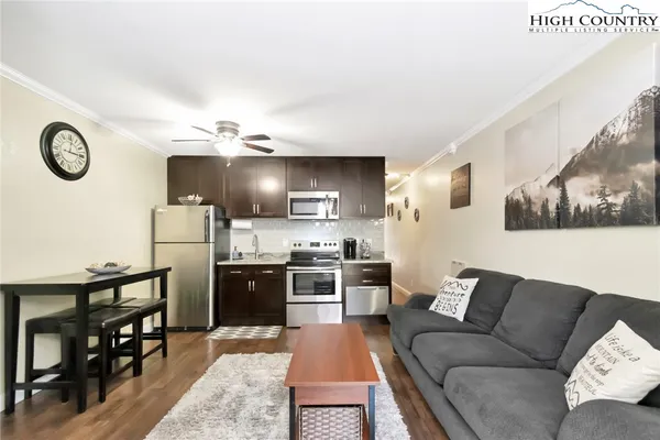 a kitchen with stainless steel appliances granite countertop a refrigerator and stove