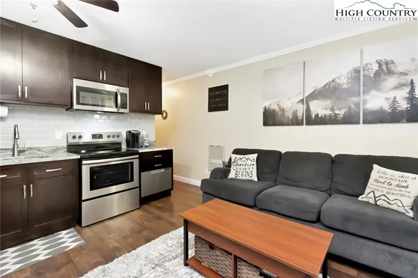 a living room with furniture and kitchen view