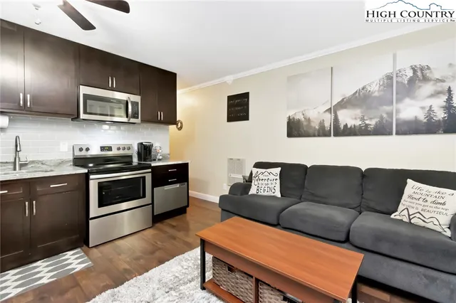 a living room with furniture and kitchen view